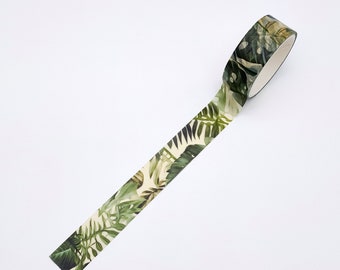 May include: A roll of decorative adhesive tape featuring a repeating pattern of various green tropical leaves, including monstera and fern foliage, set against a light cream background. The tape is partially unrolled to display the botanical design.