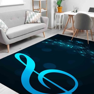 May include: A blue and black rug with a large treble clef design. The rug features a dark blue background with a light blue treble clef and musical notes.