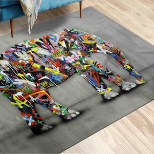 Puede incluir: Una alfombra gris con un diseño de elefante abstracto de colores. El elefante está hecho de varios tonos de azul, verde, rojo, amarillo y rosa.