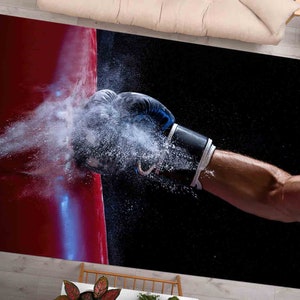 May include: A gloved fist punches through a cloud of white powder, striking a red surface. The background is black.