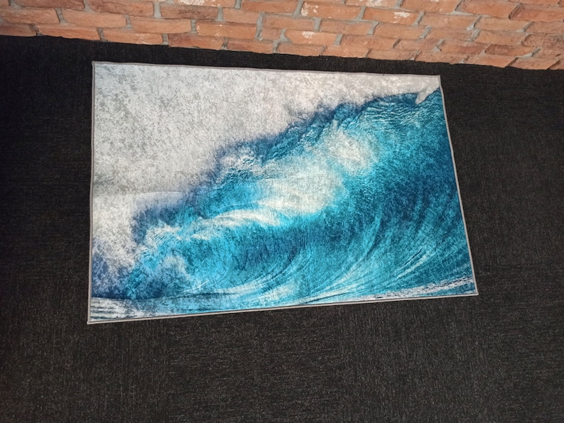 May include: A blue and white rug with a wave design. The rug has a light gray border.