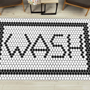 May include: Black and white hexagonal tile rug with a black border and the word "WABI" in the center.