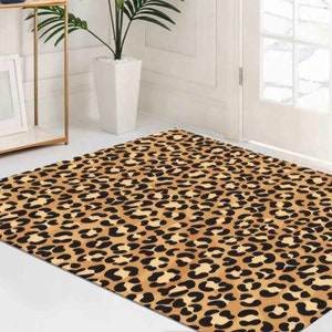 May include: A brown and black leopard print area rug. The rug has a repeating pattern of black spots on a brown background.