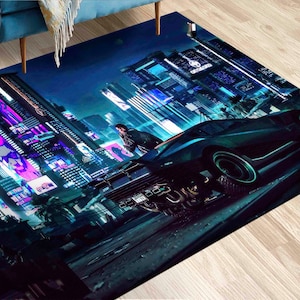 May include: A dark blue and teal rug with a futuristic city scene. The rug features a black car with glowing lights, a person in a black jacket, and neon signs with text that reads "Occidental".