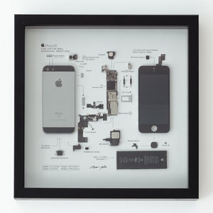 May include: A disassembled iPhone 5c in a black frame. The phone's components are laid out on a white background with labels identifying each part. The phone's screen, camera, battery, and other parts are visible. The text "iPhone 5c A BIG STEP FOR SMALL INTRODUCED MARCH 2016" is printed on the frame.