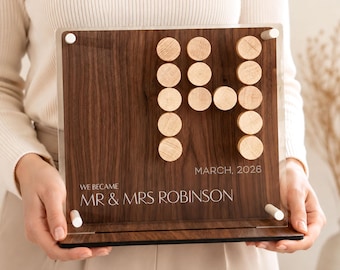 May include: A rectangular wooden plaque with a clear acrylic front panel held by four white standoffs. The wood features a dark grain and is decorated with light-colored wooden circles arranged in a pattern. Text reads: WE BECAME MR & MRS ROBINSON MARCH, 2026.