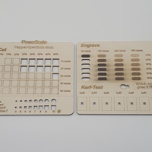May include: A wooden laser cutting test board with a grid of squares for testing cut depth and speed, a row of circles for testing font sizes, and a section for testing engraving depth and speed. The board also includes a kerf test to measure the width of the cut.