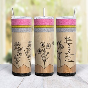 May include: Three stainless steel tumblers with a wood grain design and a pink, gold, and gray glitter top. The tumblers feature a floral design and the name "Meredith" on one of the tumblers.