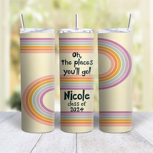 May include: A set of three stainless steel tumblers with a retro rainbow design. The tumblers are cream colored with a rainbow pattern in shades of orange, yellow, pink, and blue. The middle tumbler has the text "Oh, the places you'll go!" and "Nicole class of 2024".