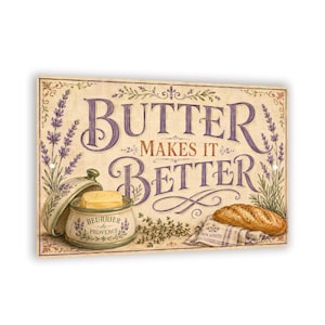 May include: A rectangular metal sign featuring the text "BUTTER MAKES IT BETTER" in purple and brown. The design includes illustrations of lavender sprigs, a ceramic butter dish with a lid, a block of butter, and a loaf of bread on a cloth.
