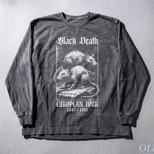 May include: Pepper-colored long-sleeve shirt with a graphic featuring two rats and the text "Black Death European Tour 1347-1351." The shirt has a vintage, distressed look.