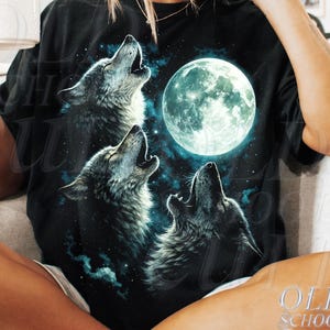 May include: Black t-shirt with a graphic of three wolves howling at a full moon. The design includes a starry night sky and a glowing moon. The text "OLD SCHOOL CULT" is printed on the bottom right.