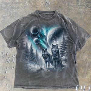 May include: A dark gray t-shirt with a graphic print of two wolves standing in a snowy forest under a starry sky with a large planet and a blue aurora.