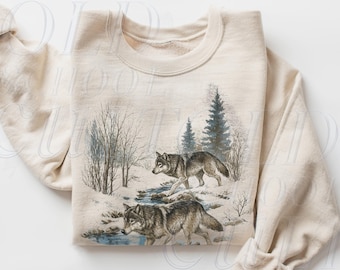 May include: Sand-coloured sweatshirt with a detailed illustration of two wolves in a snowy forest scene. The graphic includes trees, a stream, and a winter landscape. The text "OLD SCHOOL CULT" is visible in the lower right corner.