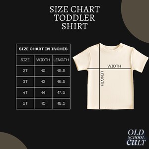 May include: Size chart for toddler shirts in inches. The chart shows the width and length measurements for sizes 2T, 3T, 4T, and 5T.