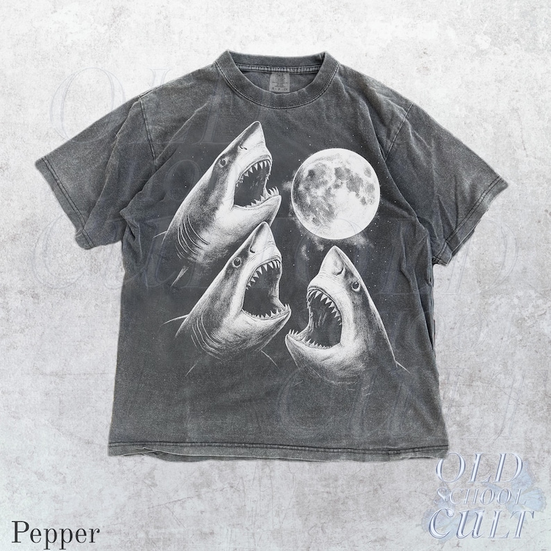 May include: Pepper-colored t-shirt featuring a graphic of three sharks with open mouths and a full moon. The design is in white against a dark gray background. The text "OLD SCHOOL CULT" and "Pepper" are visible.