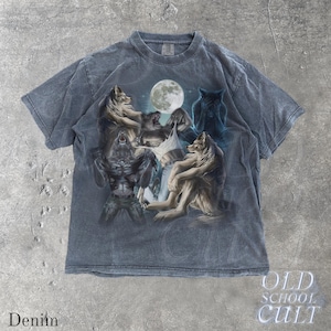 May include: Denim-colored t-shirt featuring a graphic of wolves and a werewolf under a full moon. The design includes various wolf poses and a mystical, fantasy theme. The text "OLD SCHOOL CULT" is visible.