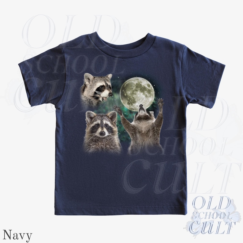 May include: Navy blue t-shirt featuring a graphic of three raccoons with a full moon in the background. One raccoon is looking up at the moon with its arms raised. The text "OLD SCHOOL CULT" is printed on the shirt.