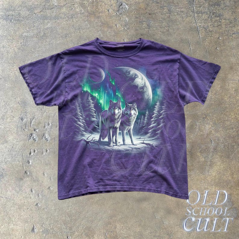 May include: Purple t-shirt with a graphic print of two wolves howling at the moon with a green aurora borealis in the background.