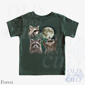 May include: Forest green t-shirt featuring a graphic of three raccoons and a full moon. One raccoon is looking up at the moon with its arms raised. The text "OLD SCHOOL CULT" is printed on the bottom right.