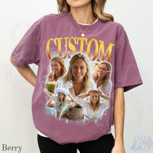 May include: Berry-colored t-shirt with a custom design featuring multiple images of a person. The word "CUSTOM" is printed in gold across the top. The shirt is a relaxed fit and has short sleeves.