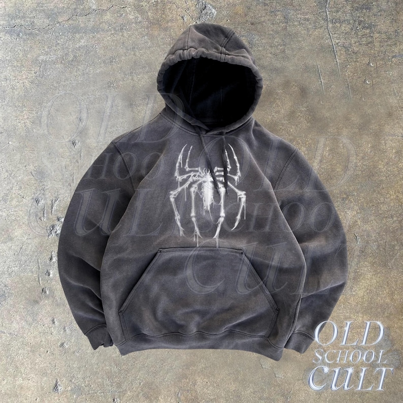 May include: A black hooded sweatshirt with a white spider graphic on the front. The sweatshirt has a distressed look and the text "OLD SCHOOL CULT" is printed on the bottom right corner.