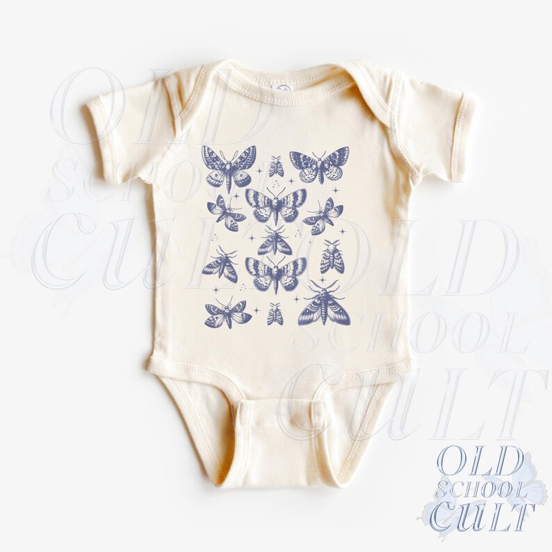 May include: Cream-colored baby onesie featuring a collection of blue butterfly and moth illustrations. The design includes various sizes and styles of the insects, creating a whimsical pattern. The text "OLD SCHOOL CULT" is printed on the bottom right.