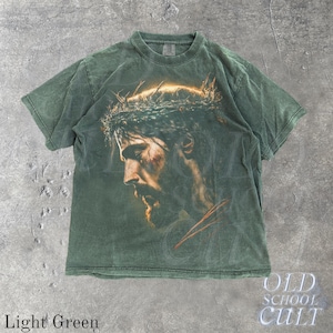 May include: Light green t-shirt featuring a detailed portrait of a man with a crown of thorns. The image is printed on the front of the shirt. The words "OLD SCHOOL CULT" are printed on the bottom right corner. The words "Light Green" are printed on the bottom left corner.