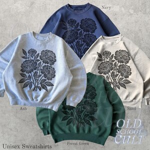May include: Four unisex sweatshirts in navy, ash, sand, and forest green. Each has a large floral design in a darker shade. The words "Unisex Sweatshirts" are at the bottom left. The brand name "OLD SCHOOL CULT" is visible.