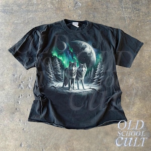 May include: Black t-shirt with a graphic print of two wolves howling at the moon with a green aurora borealis in the background.
