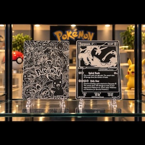 May include: Two rectangular black and white metal cards featuring Pokémon imagery. The left card displays a collage of various Pokémon characters and the Pokémon logo. The right card is a Rayquaza trading card with 90 HP and text details.