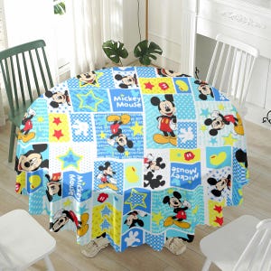 May include: A round tablecloth featuring a colorful patchwork design with images of Mickey Mouse. The design includes Mickey Mouse in various poses, stars, and the words "Mickey Mouse" in a playful font. The color scheme includes blue, yellow, red, and black.
