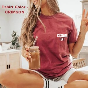 May include: A woman wearing a crimson t-shirt with a white pocket that says "CUSTOM TEXT".