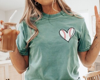 May include: A teal blue t-shirt with a red baseball heart graphic. The shirt is made of a soft, comfortable material and has a relaxed fit.