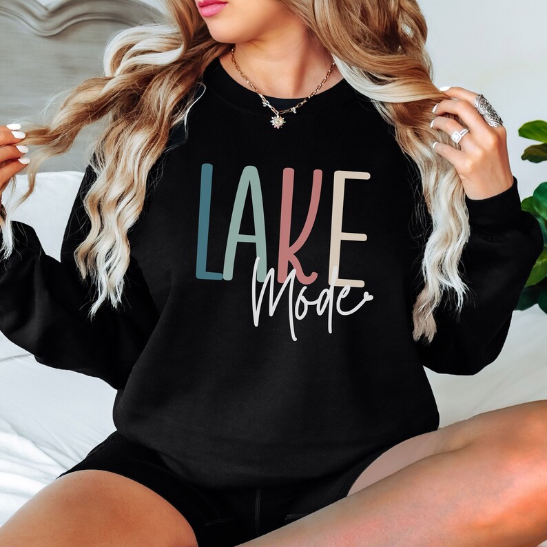 May include: Black sweatshirt with the text "LAKE Mode" in colorful letters. The letters are in shades of blue, pink, and yellow.