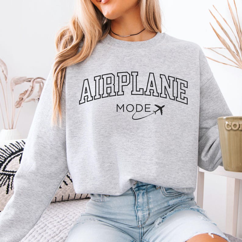 May include: A gray sweatshirt with the text "AIRPLANE MODE" in black with a small airplane graphic.