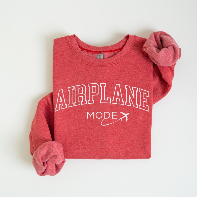 May include: Red sweatshirt with white text that reads "AIRPLANE MODE" with a small airplane graphic.