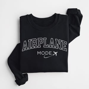 May include: Black sweatshirt with white text that reads "AIRPLANE MODE" with a stylized airplane graphic.
