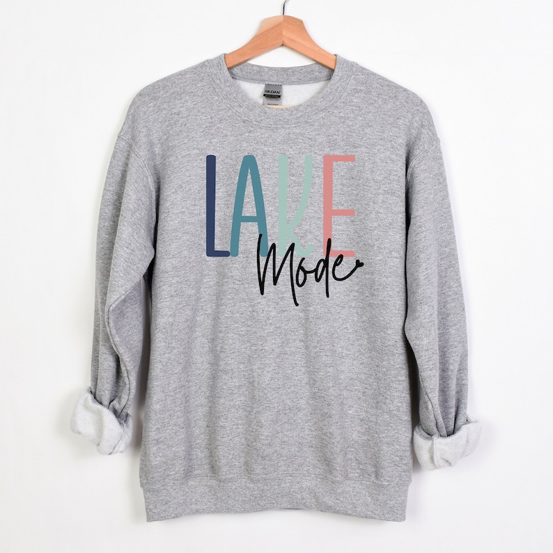 May include: Gray sweatshirt with the text "LAKE Mode" in colorful letters. The letters are in shades of blue, green, and pink.