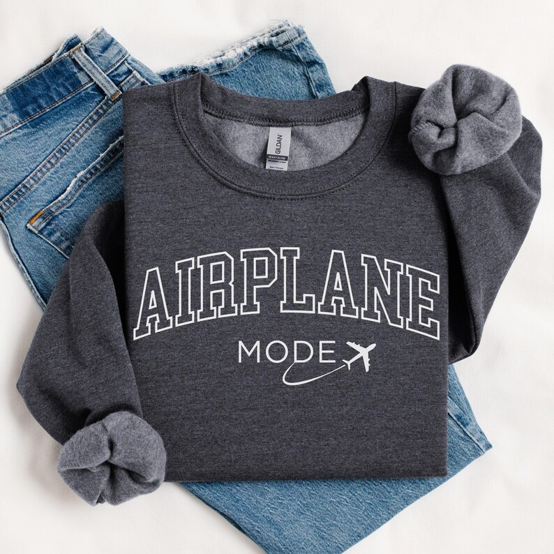 May include: A dark gray sweatshirt with the text "AIRPLANE MODE" in white, featuring a stylized airplane graphic.