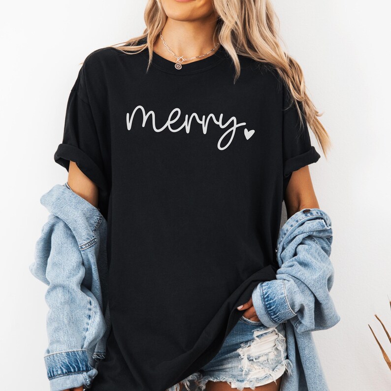 May include: A black t-shirt with the word "merry" written in white cursive with a small white heart after it.