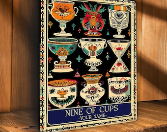 May include: A decorative sign featuring nine ornate cups in various colors and designs against a black background. The sign includes the text "NINE OF CUPS -YOUR NAME-" in a blue banner, with a decorative border.