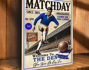 May include: A vintage-style poster for a football match. The poster features a player in a blue jersey kicking a soccer ball. The text on the poster reads "Matchday Since 1885", "KO 3PM", "Programme Come On You Lions", "Cold Blow Lane", "Welcome To The Den", and "Your Name Life Long Fan".