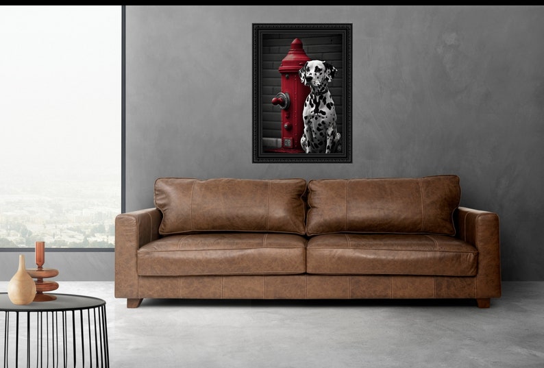 May include: A black and white Dalmatian dog sits next to a red fire hydrant in a framed photograph. The photograph is hanging on a grey wall above a brown leather sofa.