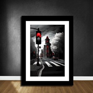 May include: A black and white city street scene with a red traffic light and a red building. The street is empty except for a car in the distance.