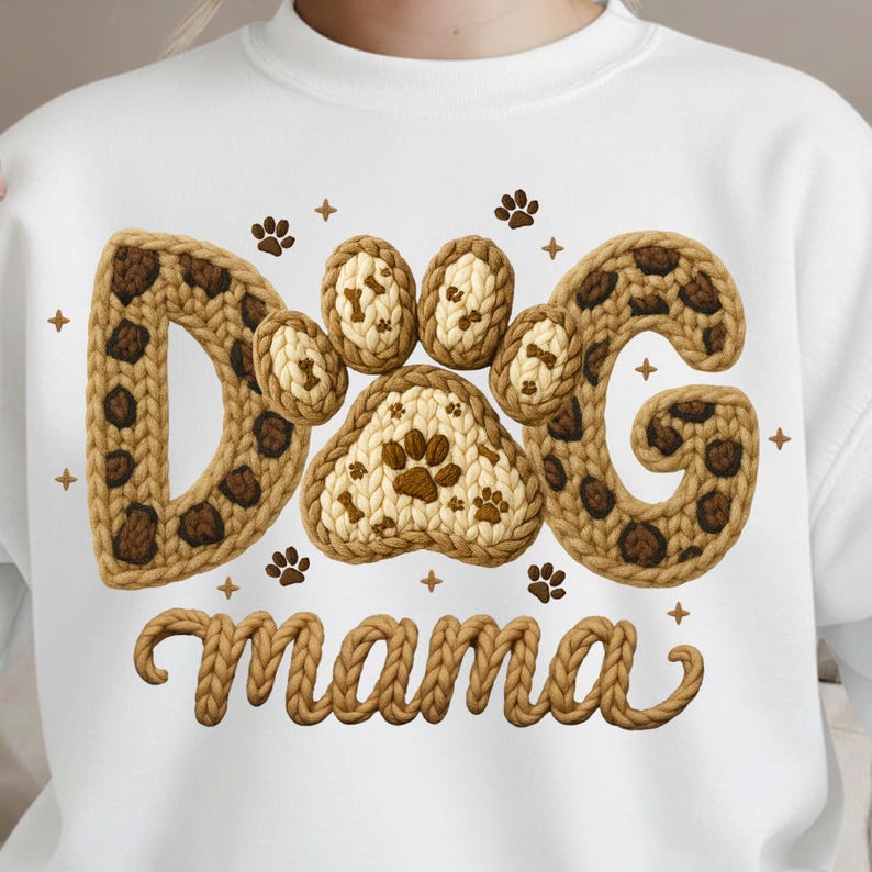 May include: White sweatshirt with a knitted design that says "Dog Mama." The letters "DOG" are in a brown leopard print pattern, and the word "mama" is in a knitted font. Paw prints and star accents complete the design.