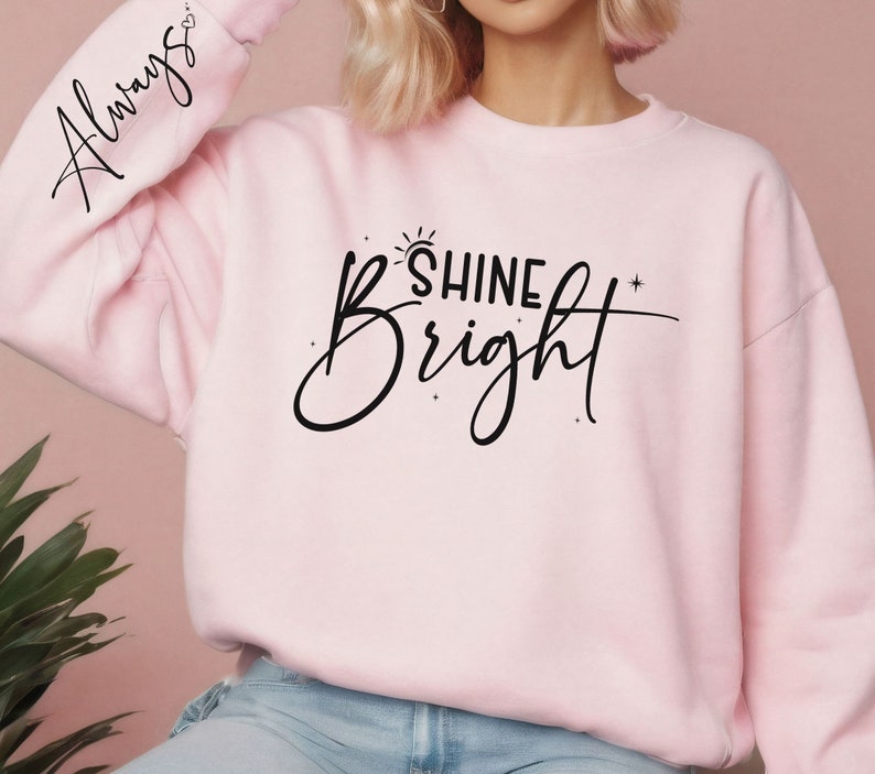 Może przedstawiać: R&oacute;żowa bluza z napisem "Always" na rękawie i "Shine Bright" z przodu.