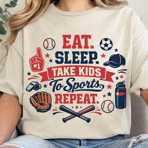 May include: Beige t-shirt with the text "EAT. SLEEP. TAKE KIDS TO SPORTS. REPEAT." in red and blue. The design includes baseballs, a soccer ball, a baseball glove, a cap, and other sports-related icons.