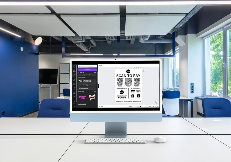 May include: A computer screen displaying a document with the text "SCAN TO PAY" and several QR codes. The document also includes a logo and social media icons. The computer is on a white desk in an office setting.