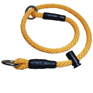 May include: Yellow rope dog collar with black rubber accents and a silver metal ring.